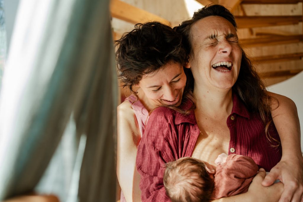 Echtes Lachen im Wochenbett – emotionale Reportagefotografie Queere Eltern